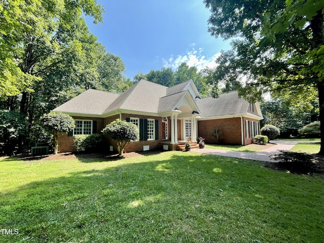 21 Covington Ln, Durham, NC 27712 - view of front of house featuring brick siding, a front lawn, and a shingled roof
