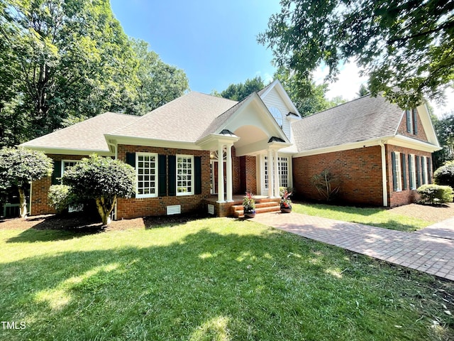 21 Covington Ln, Durham, NC 27712 - view of front of property featuring brick siding, a front lawn, and roof with shingles