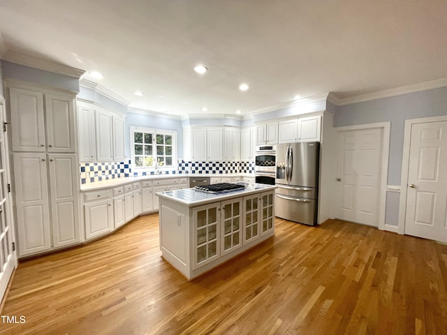 21 Covington Ln, Durham, NC 27712 - kitchen featuring stainless steel appliances, white cabinets, crown molding, light wood-style floors, and light countertops