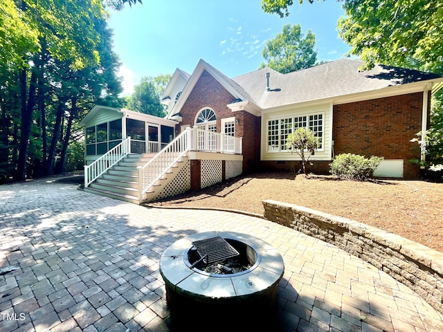 21 Covington Ln, Durham, NC 27712 - back of property featuring a sunroom, a patio, stairway, crawl space, and an outdoor fire pit