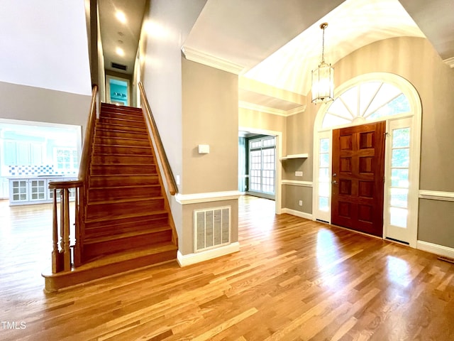 21 Covington Ln, Durham, NC 27712 - foyer with wood finished floors, stairway, a chandelier, ornamental molding, and high vaulted ceiling