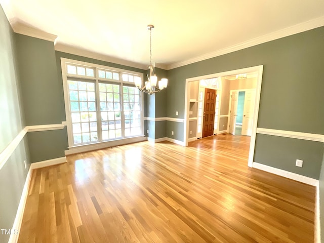 21 Covington Ln, Durham, NC 27712 - unfurnished dining area featuring a chandelier, ornamental molding, and light wood finished floors