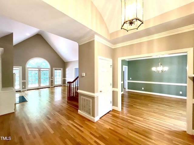 21 Covington Ln, Durham, NC 27712 - foyer entrance with a chandelier, wood finished floors, high vaulted ceiling, and stairway