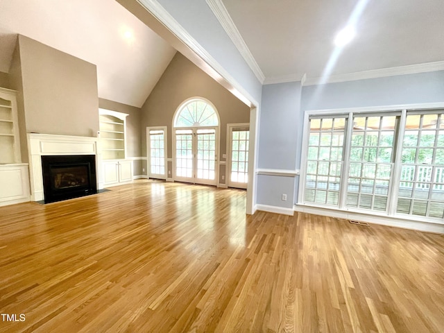21 Covington Ln, Durham, NC 27712 - unfurnished living room featuring light wood finished floors, a fireplace with flush hearth, built in features, and ornamental molding