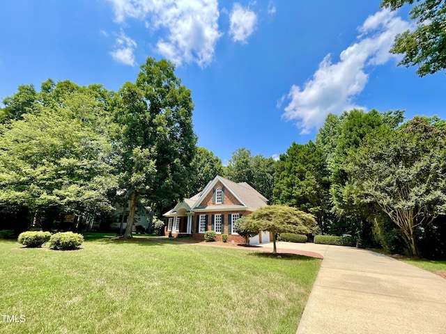 21 Covington Ln, Durham, NC 27712 - view of front of home featuring a front yard, brick siding, and driveway