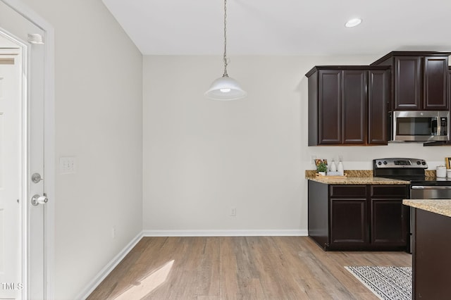 4520 Middletown Dr, Wake Forest, NC 27587 - kitchen featuring appliances with stainless steel finishes, light wood-style flooring, dark brown cabinetry, recessed lighting, and light stone countertops
