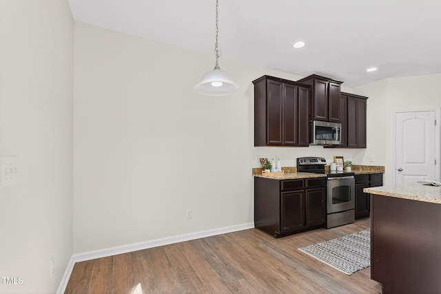 4520 Middletown Dr, Wake Forest, NC 27587 - kitchen with appliances with stainless steel finishes, light wood-style flooring, dark brown cabinetry, recessed lighting, and light stone counters