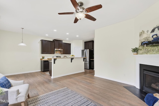 4520 Middletown Dr, Wake Forest, NC 27587 - living area with a ceiling fan, wood finished floors, recessed lighting, and a fireplace with flush hearth