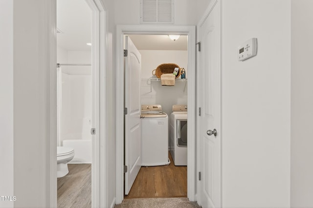 4520 Middletown Dr, Wake Forest, NC 27587 - hall featuring washing machine and clothes dryer and wood finished floors