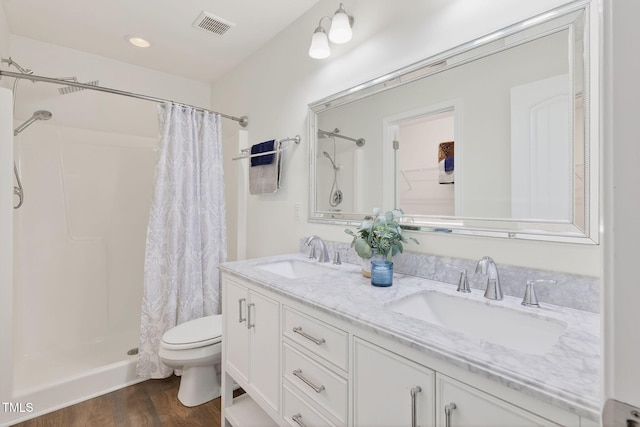 4520 Middletown Dr, Wake Forest, NC 27587 - full bathroom with curtained shower, wood finished floors, and double vanity