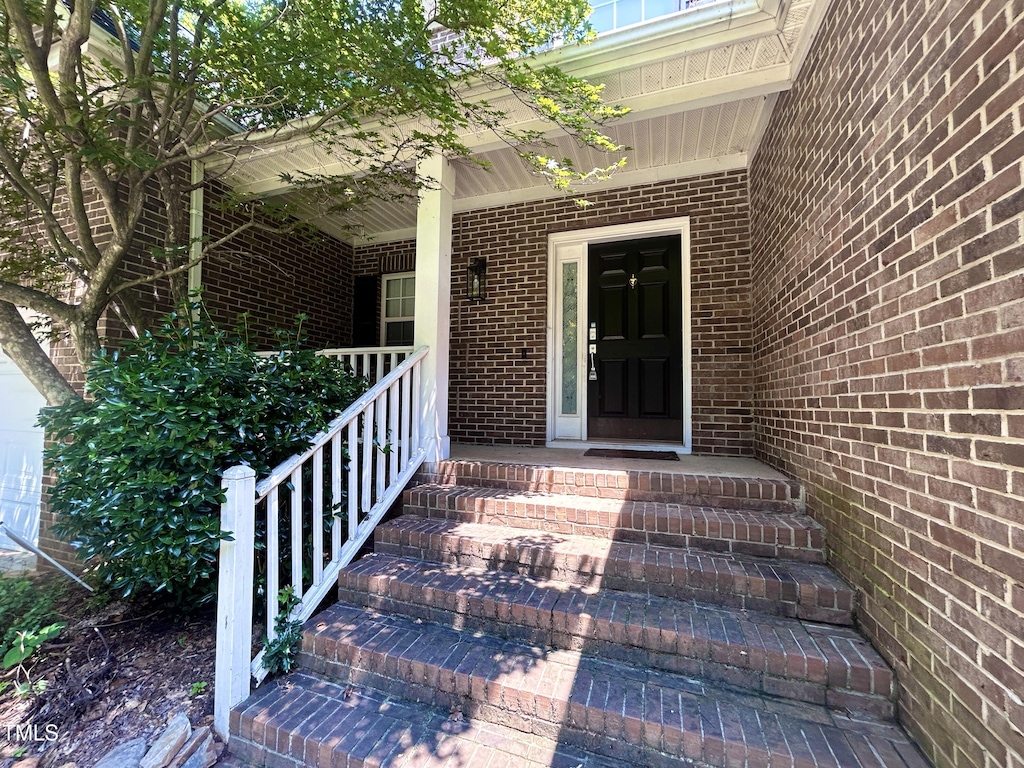 310 New Parkside Dr, Chapel Hill, NC 27516 - view of exterior entry featuring brick siding and a porch