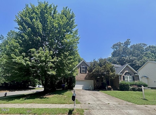 310 New Parkside Dr, Chapel Hill, NC 27516 - view of property hidden behind natural elements featuring driveway, a front lawn, an attached garage, and brick siding