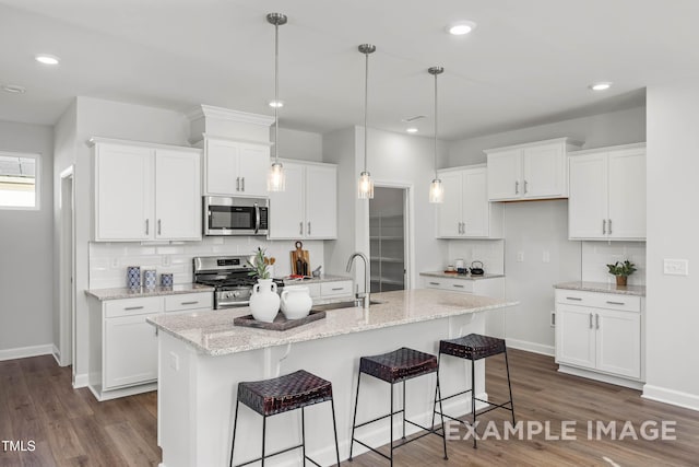 399 Old Fashioned Way, Lillington, NC 27546 - kitchen with stainless steel appliances, tasteful backsplash, white cabinets, a kitchen island with sink, and recessed lighting