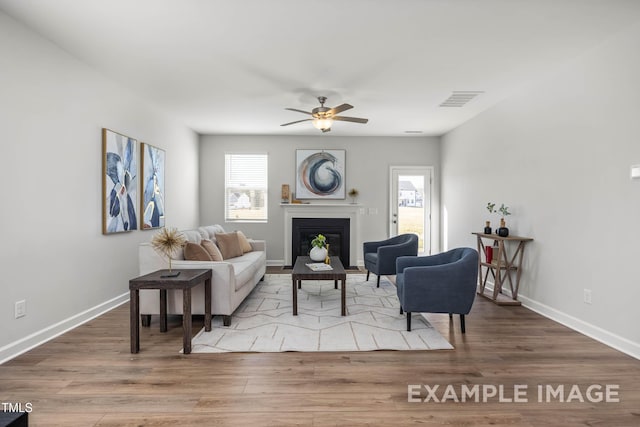 399 Old Fashioned Way, Lillington, NC 27546 - living area featuring a ceiling fan, a fireplace with flush hearth, and wood finished floors