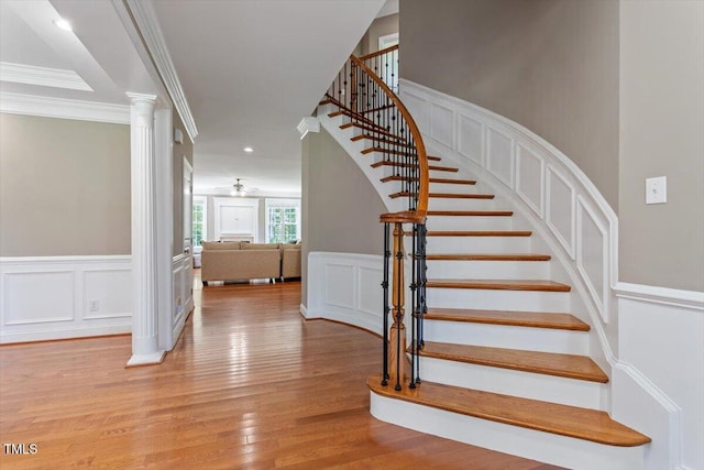 7804 Percussion Dr, Apex, NC 27539 - stairway with a decorative wall, wood finished floors, ornamental molding, a wainscoted wall, and ceiling fan