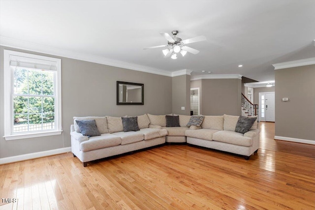 7804 Percussion Dr, Apex, NC 27539 - living area featuring light wood-style floors, stairway, crown molding, and a ceiling fan