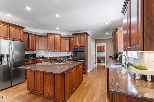7804 Percussion Dr, Apex, NC 27539 - kitchen featuring stainless steel appliances, ornamental molding, decorative backsplash, a kitchen island, and light wood finished floors