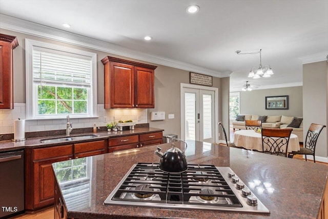 7804 Percussion Dr, Apex, NC 27539 - kitchen featuring stainless steel appliances, a chandelier, tasteful backsplash, ornamental molding, and french doors