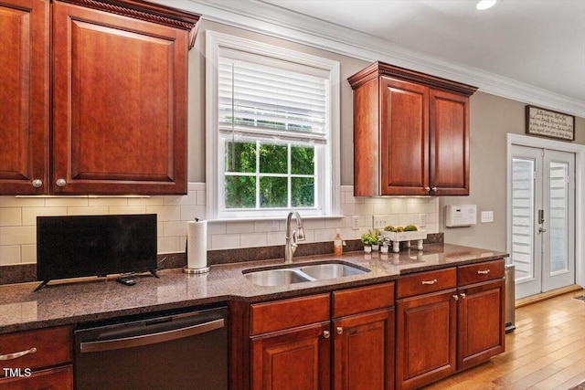 7804 Percussion Dr, Apex, NC 27539 - kitchen featuring dishwashing machine, ornamental molding, dark stone counters, and decorative backsplash