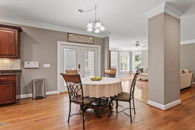 7804 Percussion Dr, Apex, NC 27539 - dining area with ornamental molding, light wood finished floors, french doors, a chandelier, and a ceiling fan