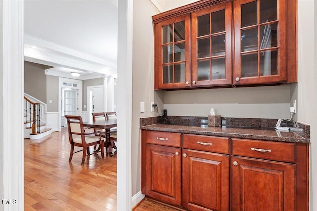 7804 Percussion Dr, Apex, NC 27539 - bar area with light wood-style flooring, crown molding, and stairs
