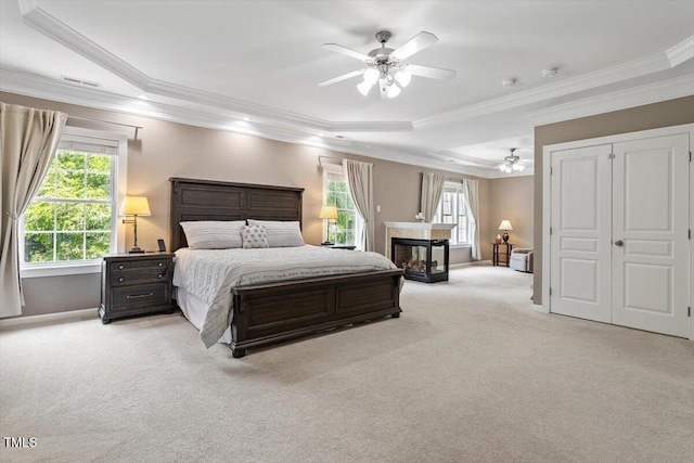 7804 Percussion Dr, Apex, NC 27539 - bedroom with carpet, multiple windows, crown molding, a tray ceiling, and a ceiling fan
