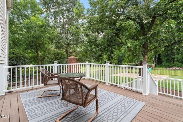 7804 Percussion Dr, Apex, NC 27539 - wooden terrace featuring view of wooded area, outdoor dining area, and a yard