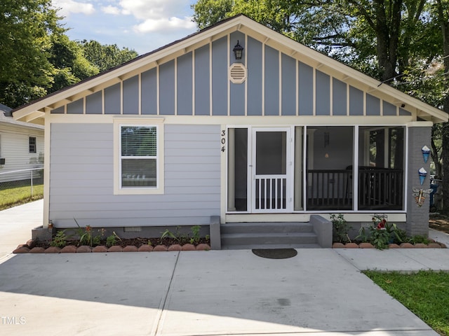 304 Spring St, Durham, NC 27703 - bungalow featuring board and batten siding, a sunroom, entry steps, and crawl space