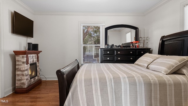 304 Spring St, Durham, NC 27703 - bedroom featuring wood finished floors, ornamental molding, and a stone fireplace