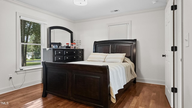 304 Spring St, Durham, NC 27703 - bedroom featuring ornamental molding, multiple windows, and wood finished floors