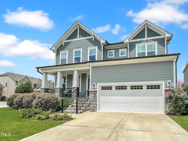 2438 Braxton Wood Ln, Apex, NC 27523 - craftsman inspired home featuring a garage, covered porch, driveway, and stone siding