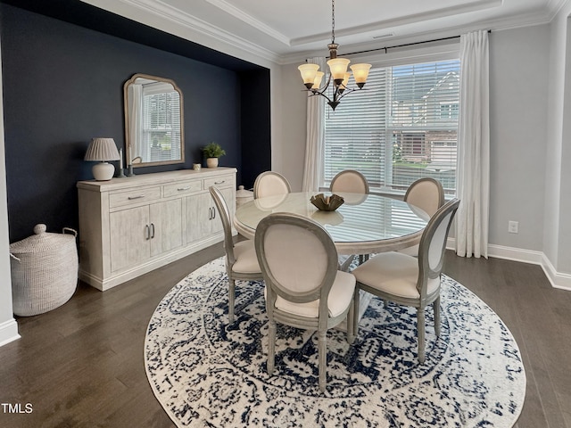 2438 Braxton Wood Ln, Apex, NC 27523 - dining room with a chandelier, a tray ceiling, dark wood-style floors, healthy amount of natural light, and crown molding