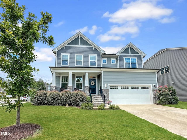 2438 Braxton Wood Ln, Apex, NC 27523 - craftsman-style home with concrete driveway, an attached garage, stone siding, a front lawn, and covered porch