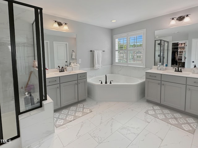 2438 Braxton Wood Ln, Apex, NC 27523 - full bath featuring marble look tile flooring, a bath, two vanities, a shower stall, and recessed lighting