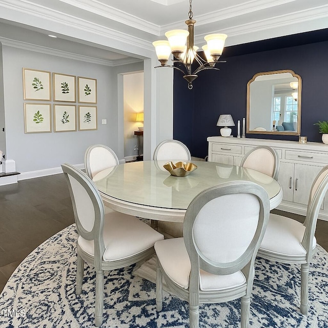 2438 Braxton Wood Ln, Apex, NC 27523 - dining area with a chandelier, dark wood-type flooring, and crown molding