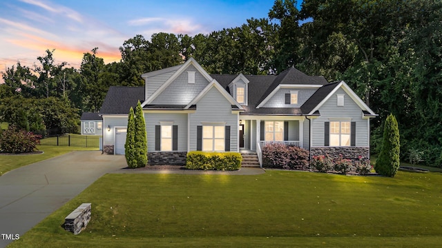4125 Olde Judd Dr, Willow Springs, NC 27592 - view of front of house featuring concrete driveway, stone siding, a garage, and a porch