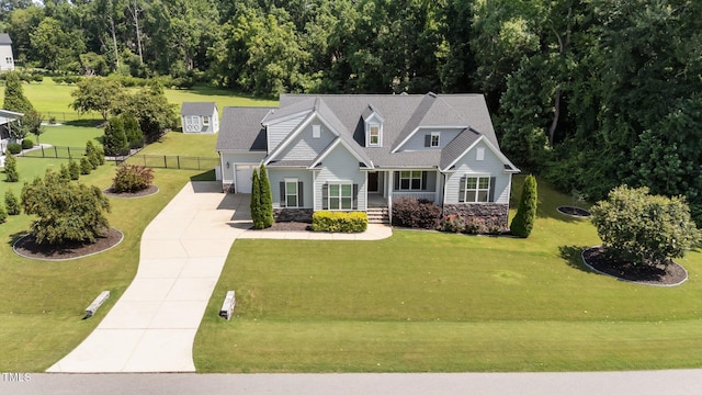 4125 Olde Judd Dr, Willow Springs, NC 27592 - view of front facade featuring driveway, an attached garage, a porch, and stone siding