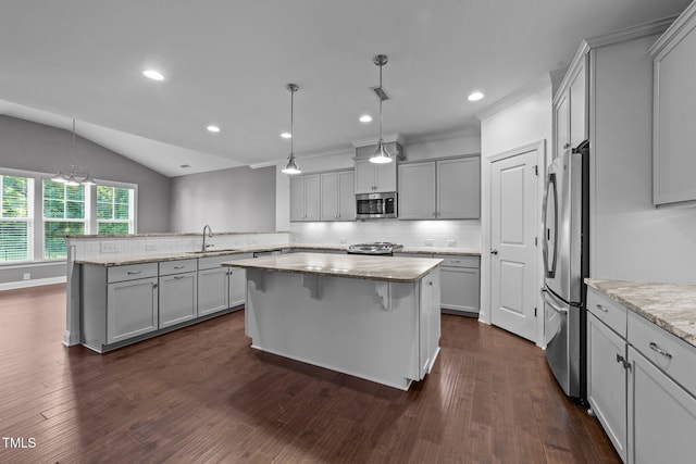 4125 Olde Judd Dr, Willow Springs, NC 27592 - kitchen featuring stainless steel appliances, a peninsula, tasteful backsplash, gray cabinets, and vaulted ceiling