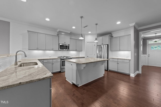4125 Olde Judd Dr, Willow Springs, NC 27592 - kitchen featuring appliances with stainless steel finishes, gray cabinetry, light stone counters, decorative backsplash, and dark wood-type flooring