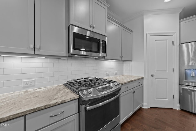 4125 Olde Judd Dr, Willow Springs, NC 27592 - kitchen with stainless steel appliances, dark wood-style floors, ornamental molding, gray cabinetry, and tasteful backsplash