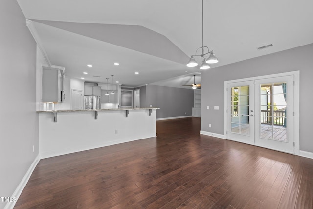 4125 Olde Judd Dr, Willow Springs, NC 27592 - unfurnished living room with vaulted ceiling, dark wood-type flooring, a ceiling fan, a chandelier, and french doors