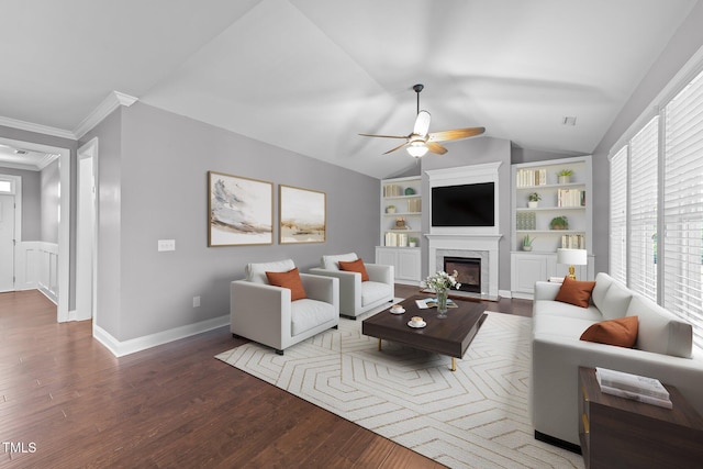 4125 Olde Judd Dr, Willow Springs, NC 27592 - living room with a ceiling fan, built in shelves, vaulted ceiling, wood finished floors, and a glass covered fireplace