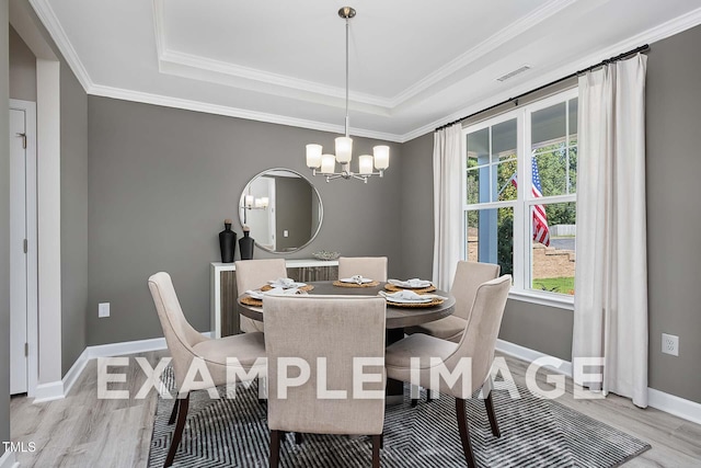 173 Old Fashioned Way, Lillington, NC 27546 - dining area featuring a chandelier, light wood-style flooring, a tray ceiling, and crown molding