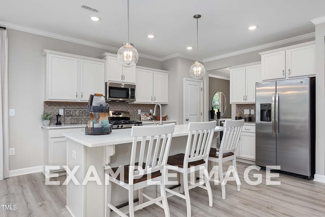 173 Old Fashioned Way, Lillington, NC 27546 - kitchen featuring appliances with stainless steel finishes, tasteful backsplash, light wood-style flooring, light countertops, and white cabinets