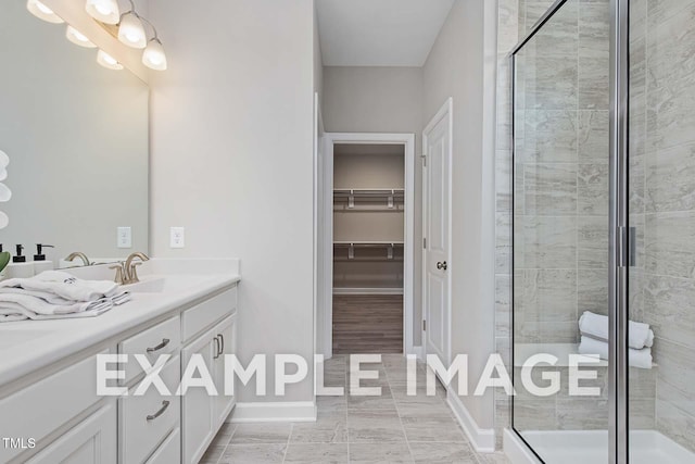 173 Old Fashioned Way, Lillington, NC 27546 - bathroom with double vanity, a shower stall, and a walk in closet