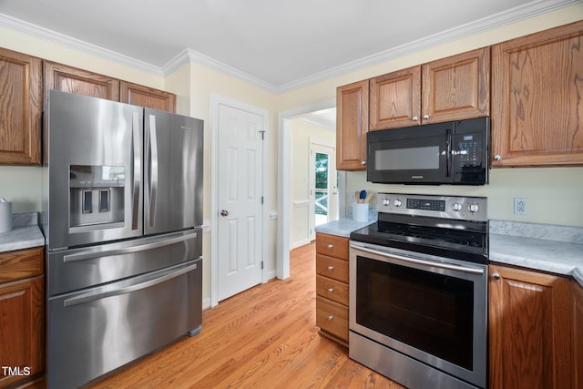 1010 Oakgrove Dr, Knightdale, NC 27545 - kitchen featuring appliances with stainless steel finishes, light wood-style flooring, light countertops, crown molding, and brown cabinetry