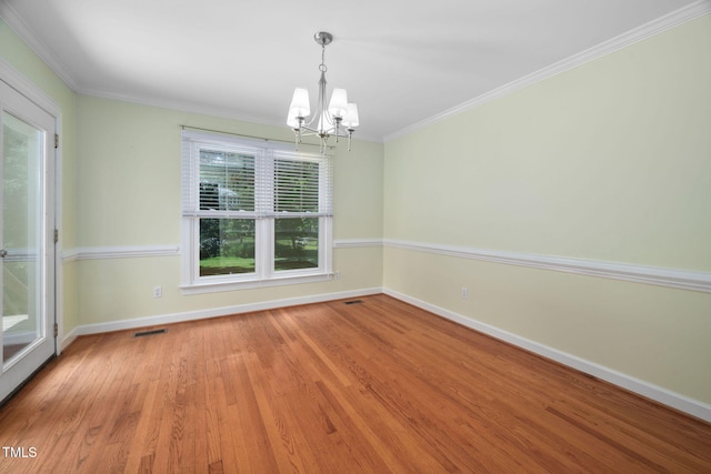 1010 Oakgrove Dr, Knightdale, NC 27545 - spare room with a chandelier, wood finished floors, and ornamental molding