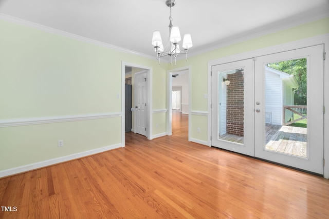 1010 Oakgrove Dr, Knightdale, NC 27545 - unfurnished dining area featuring a chandelier, french doors, light wood-type flooring, and crown molding