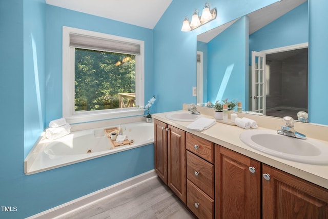 1010 Oakgrove Dr, Knightdale, NC 27545 - full bath with double vanity, wood finished floors, and a jetted tub