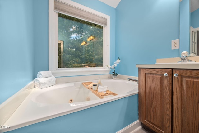1010 Oakgrove Dr, Knightdale, NC 27545 - bathroom with vanity, a jetted tub, and healthy amount of natural light